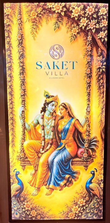 Radha-Krishna artwork on a floral swing, displayed at Hotel Saket Villa